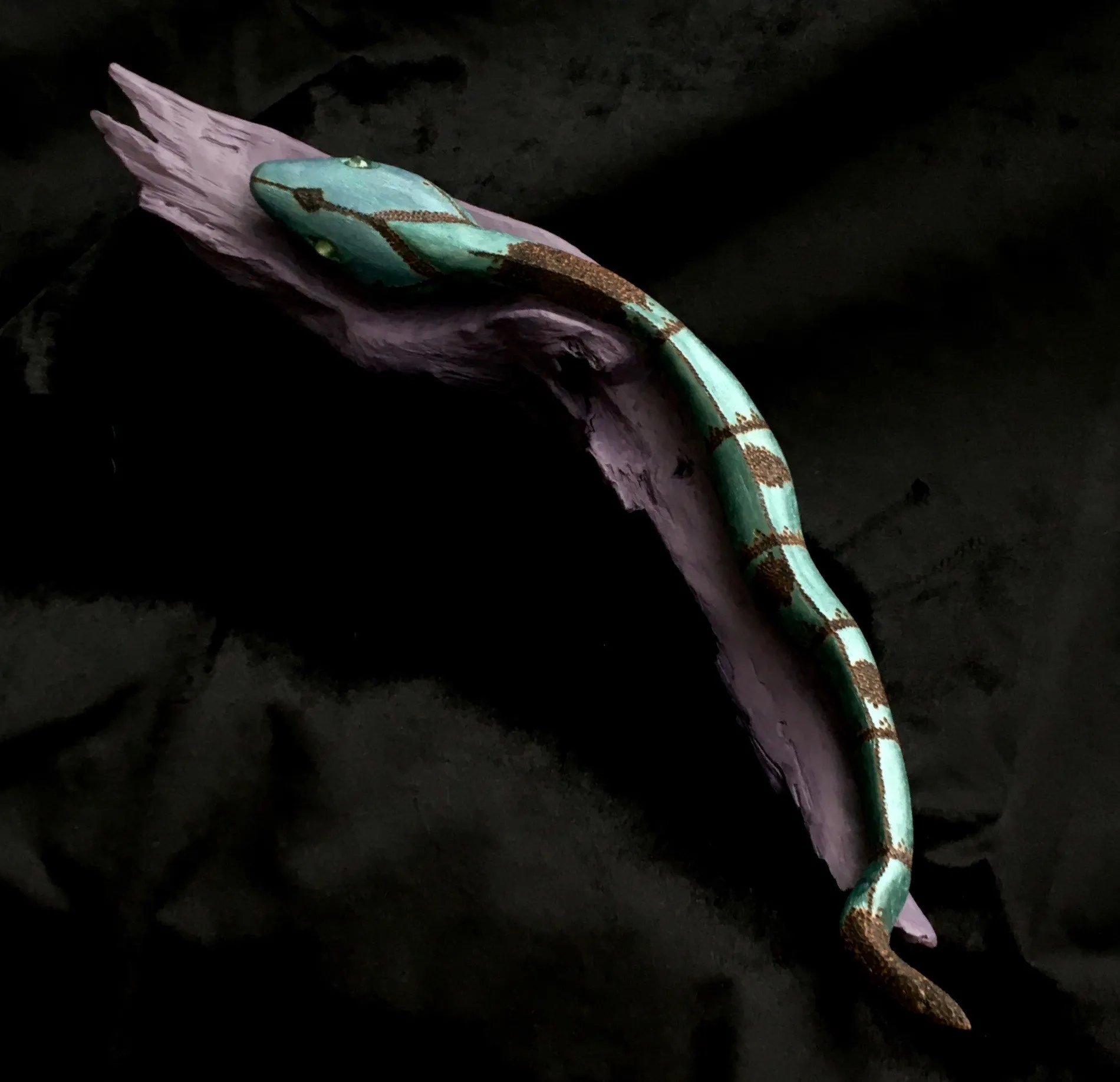 A snake shaped wooden sculpture